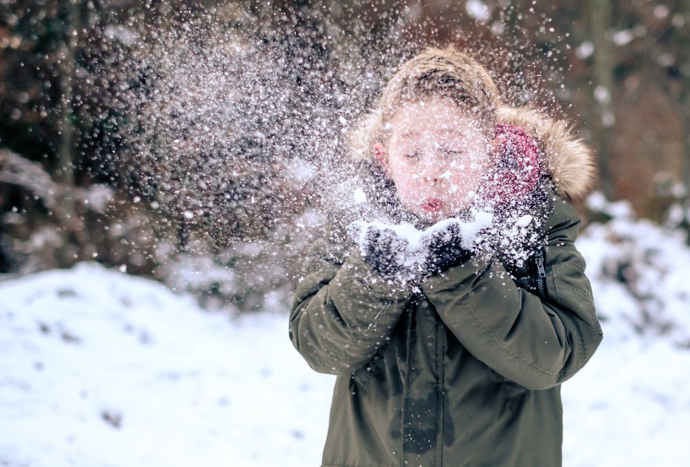 child_blowing_snow